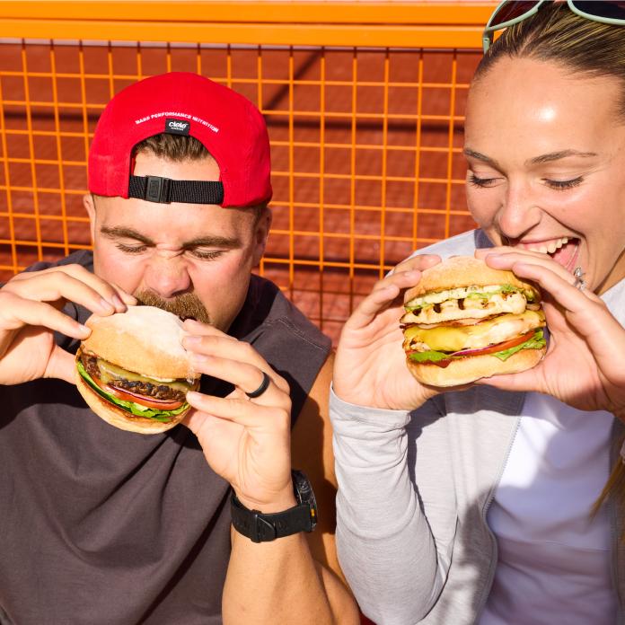 Couple eating Grill'd High Performance Range burgers